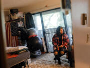 Janell Braxton is reflected in a mirror as she visits with her mother Debra Braxton at Debra&Ccedil;&fnof;&Ugrave;s apartment in Shoreline, Oct. 17, 2023. Braxton spent 12 years in and out of the foster system and then homeless for several years once she aged out. She now works to help other youth transitioning out of the system.