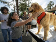 Naillah Benjell of Los Angeles greets Maximus Mighty-Dog Mueller III, otherwise known as Mayor Max III, the mayor of Idyllwild, during a public appearance.