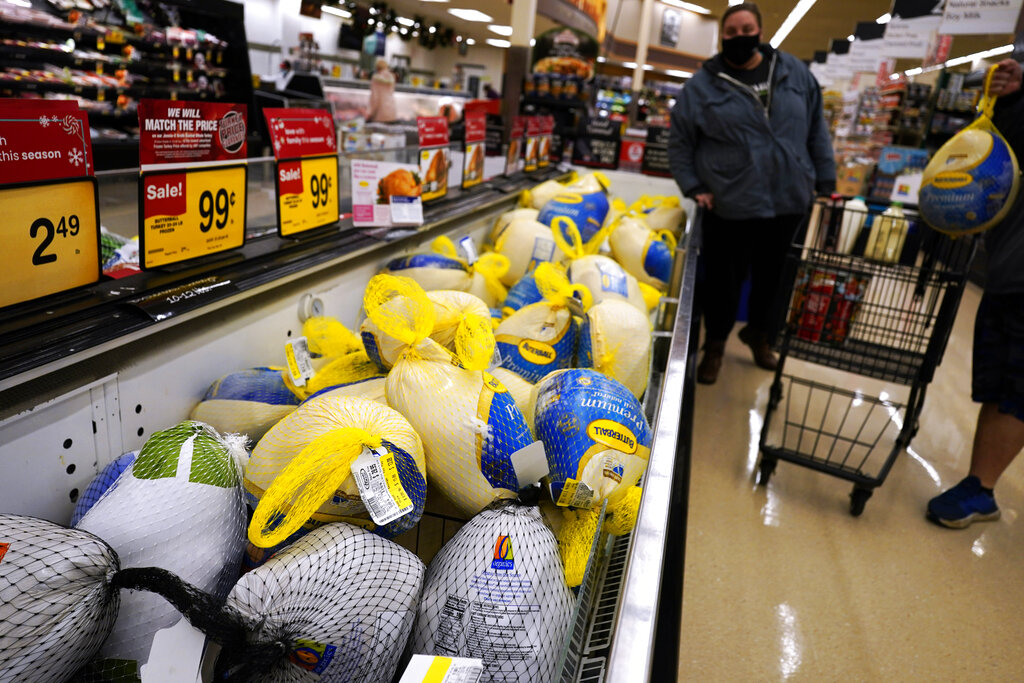 People shop for frozen turkeys for Thanksgiving dinner at a grocery store in 2021. (AP Photo/Nam Y.