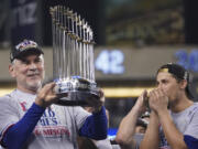 Texas Rangers manager Bruce Bochy holds up the trophy after Game 5 of the baseball World Series against the Arizona Diamondbacks Wednesday, Nov. 1, 2023, in Phoenix. The Rangers won 5-0 to win the series 4-1. (AP Photo/Godofredo A.