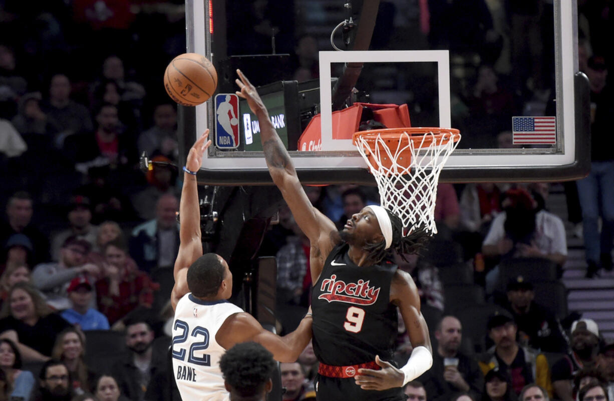 Portland Trail Blazers forward Jerami Grant, right, blocks a shot by Memphis Grizzlies guard Desmond Bane, left, during the first half of an NBA basketball game in Portland, Ore., Friday, Nov. 3, 2023.