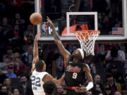Portland Trail Blazers forward Jerami Grant, right, blocks a shot by Memphis Grizzlies guard Desmond Bane, left, during the first half of an NBA basketball game in Portland, Ore., Friday, Nov. 3, 2023.