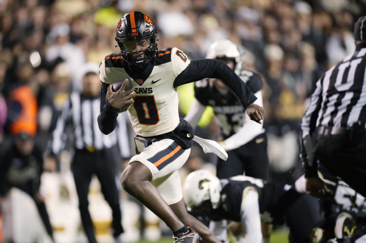 Oregon State quarterback Aidan Chiles runs for a touchdown against Colorado in the first half of an NCAA college football game Saturday, Nov. 4, 2023, in Boulder, Colo.