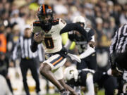 Oregon State quarterback Aidan Chiles runs for a touchdown against Colorado in the first half of an NCAA college football game Saturday, Nov. 4, 2023, in Boulder, Colo.