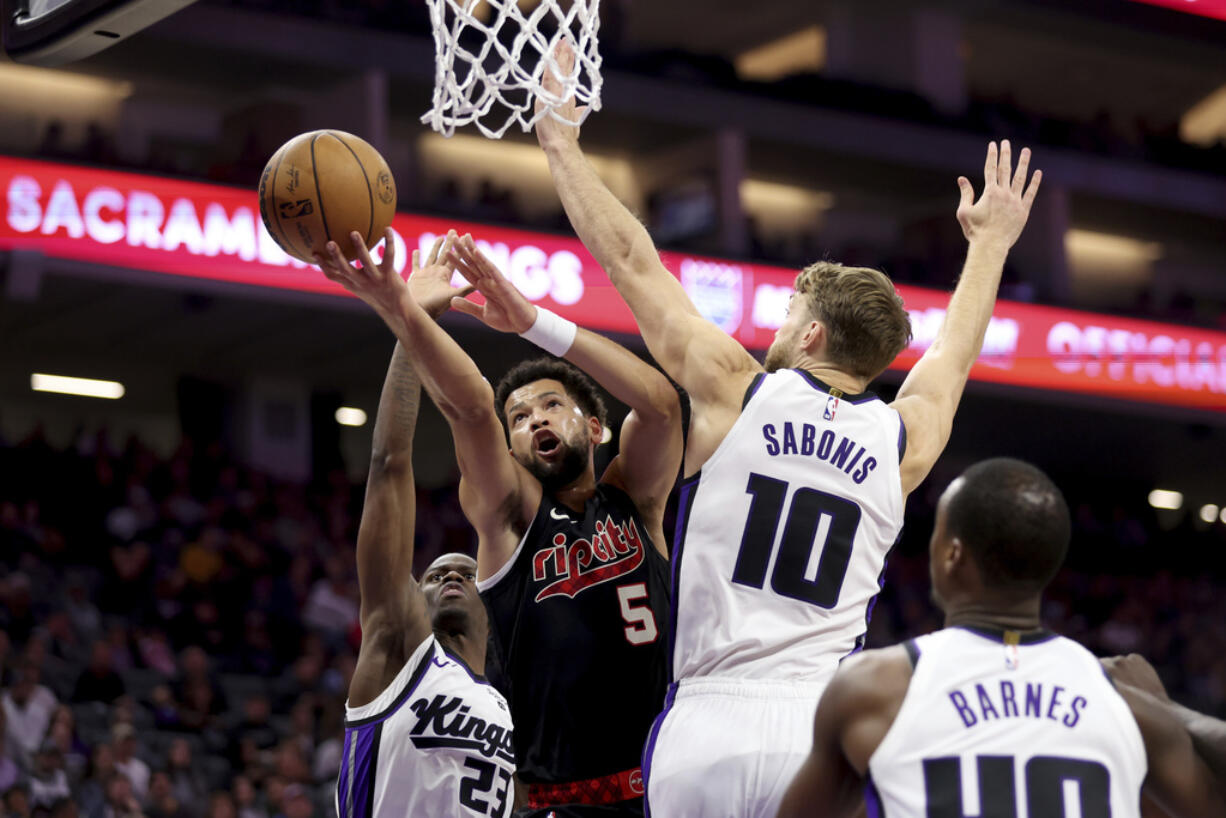 Portland Trail Blazers guard Skylar Mays (5) shoots against Sacramento Kings forward Domantas Sabonis (10) during the first half of an NBA basketball game in Sacramento, Calif, Wednesday, Nov. 8, 2023.