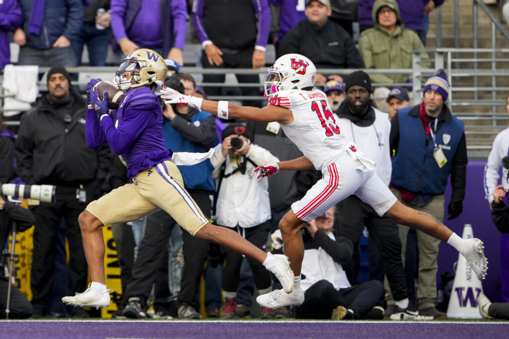 Washington wide receiver Rome Odunze, left, makes a touchdown catch in front of Utah cornerback Tao Johnson (15) during the first half of an NCAA college football game Saturday, Nov. 11, 2023, in Seattle.