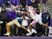 Washington wide receiver Rome Odunze, left, makes a touchdown catch in front of Utah cornerback Tao Johnson (15) during the first half of an NCAA college football game Saturday, Nov. 11, 2023, in Seattle.