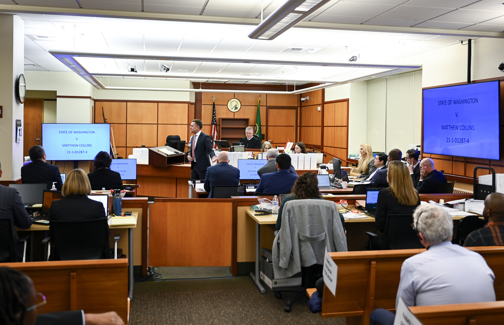 Defense attorney Casey Arbenz, center left, gives opening statements on behalf of defendant Matthew Collins during the trial of three Tacoma Police officers in the killing of Manny Ellis at Pierce County Superior Court, Monday, Nov. 13, 2023, in Tacoma, Wash. Tacoma Police Officers Christopher Burbank, Matthew Collins and Timothy Rankine stand trial for charges related to the March 2020 killing of Manny Ellis.