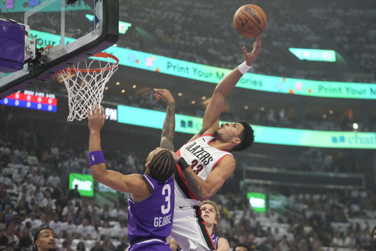 Portland Trail Blazers forward Toumani Camara shoots as Utah Jazz guard Keyonte George (3) defends during the first half of an NBA basketball in-season tournament game, Tuesday, Nov. 14, 2023, in Salt Lake City.