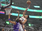 Portland Trail Blazers forward Toumani Camara shoots as Utah Jazz guard Keyonte George (3) defends during the first half of an NBA basketball in-season tournament game, Tuesday, Nov. 14, 2023, in Salt Lake City.