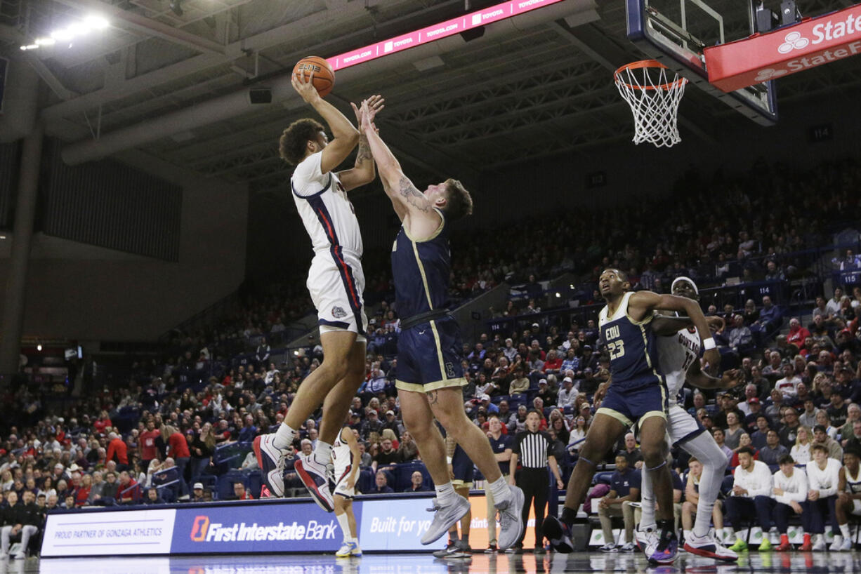 Gonzaga forward Anton Watson, left, shoots while pressured by Eastern Oregon guard Preston Chandler during the first half of an NCAA college basketball game, Tuesday, Nov. 14, 2023, in Spokane, Wash.