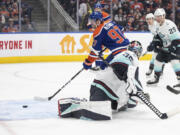 Seattle Kraken goalie Joey Daccord (35) is scored on by Edmonton Oilers' Connor McDavid (97) during the second period of an NHL hockey game, Wednesday, Nov. 15, 2023 in Edmonton, Alberta.