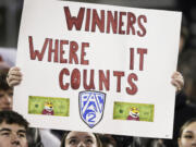 A Washington State fan holds a "Pac-2" sign before an NCAA college football game between Washington State and Colorado, Friday, Nov. 17, 2023, in Pullman, Wash. Washington State is one of two schools remaining in the Pac-12 after the 2023-2024 academic year after the other schools in the conference announced plans to leave.