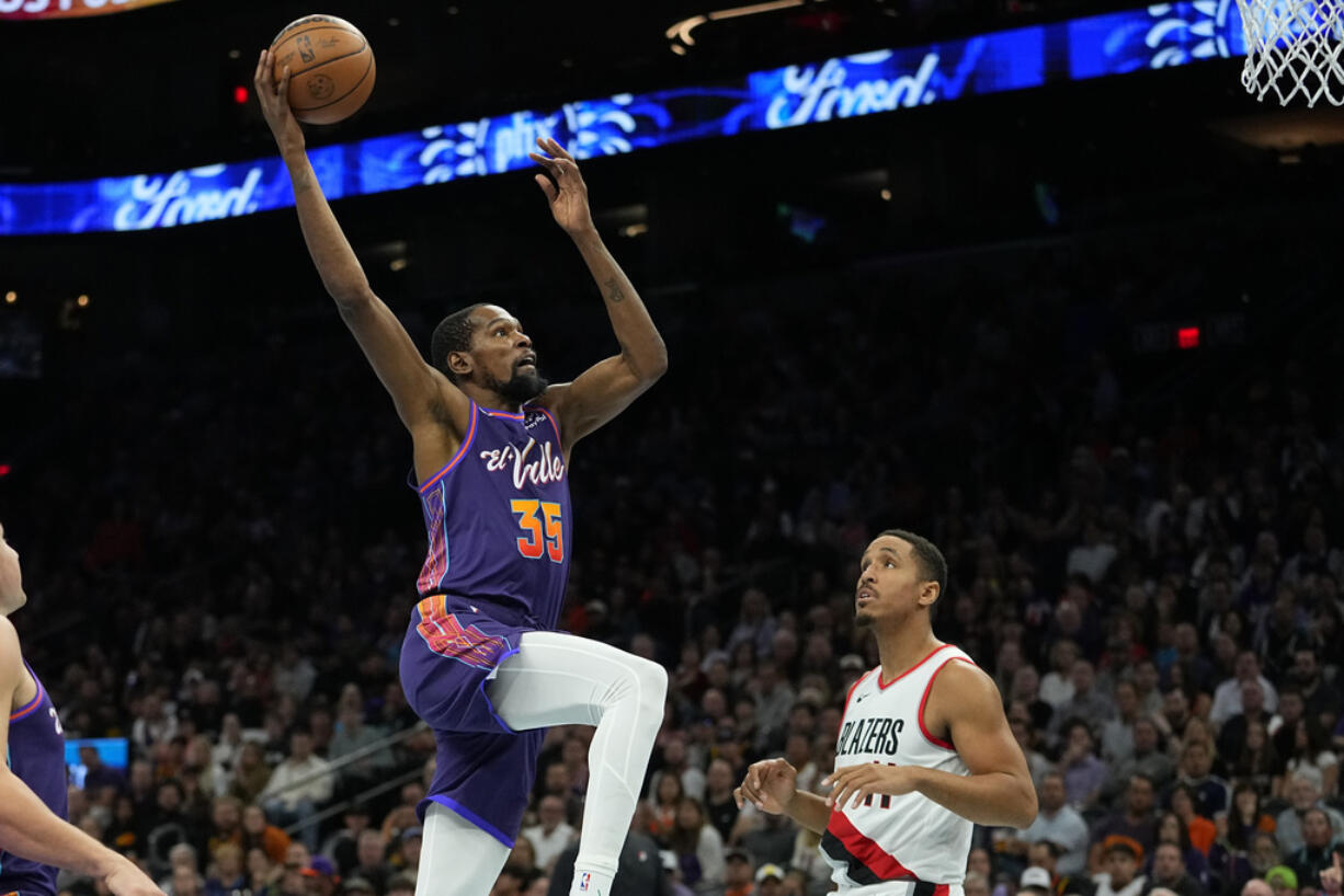 Phoenix Suns forward Kevin Durant (35) dunks against the Portland Trail Blazers during the second half of an NBA In-Season Tournament basketball game, Tuesday, Nov. 21, 2023, in Phoenix.