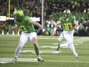 Oregon quarterback Bo Nix (10) runs for a touchdown during the first half of an NCAA college football game against Oregon State, Friday, Nov. 24, 2023, in Eugene, Ore.