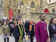 FILE - Clergy who filed suit seeking to overturn Missouri&rsquo;s abortion law and other opponents of the law hold a March through downtown St. Louis on Thursday, Jan. 19, 2023. A St. Louis judge on Thursday, Nov. 16, 2023 will hear arguments in a lawsuit challenging Missouri&rsquo;s abortion ban on the grounds that lawmakers who passed the measure imposed their own religious beliefs on others who don&rsquo;t share them. The lawsuit was filed in January on behalf of 13 Christian, Jewish and Unitarian Universalist leaders who support abortion rights.