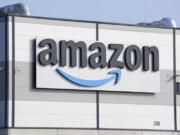 FILE - An Amazon company logo marks the facade of a building, March 18, 2022, in Schoenefeld near Berlin. Amazon said Thursday, Nov. 2, 2023, that it will close two &ldquo;Amazon Style&rdquo; stores located in Los Angeles and Columbus, Ohio, making it the latest brick-and-mortar business abandoned by Amazon. Both stores will close next week.
