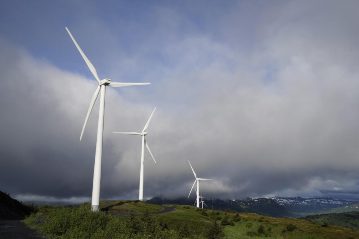 FILE - Wind turbines work on Sunday, June 25, 2023, in Kodiak, Alaska. To meet the goal of limiting global warming to 1.5 degrees Celsius (2.7 degrees Fahrenheit), nine major Asian economies must increase the share of electricity they get from renewable energy from the current 6% to at least 50% by 2030, according to a report by a German thinktank released Wednesday, Nov. 15, 2023. (AP Photo/Joshua A.