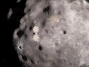 This image from a video animation provided by NASA depicts the Lucy spacecraft approaching an asteroid. On Wednesday, Nov. 1, 2023, Lucy  encountered the first of 10 asteroids on its long journey to Jupiter.