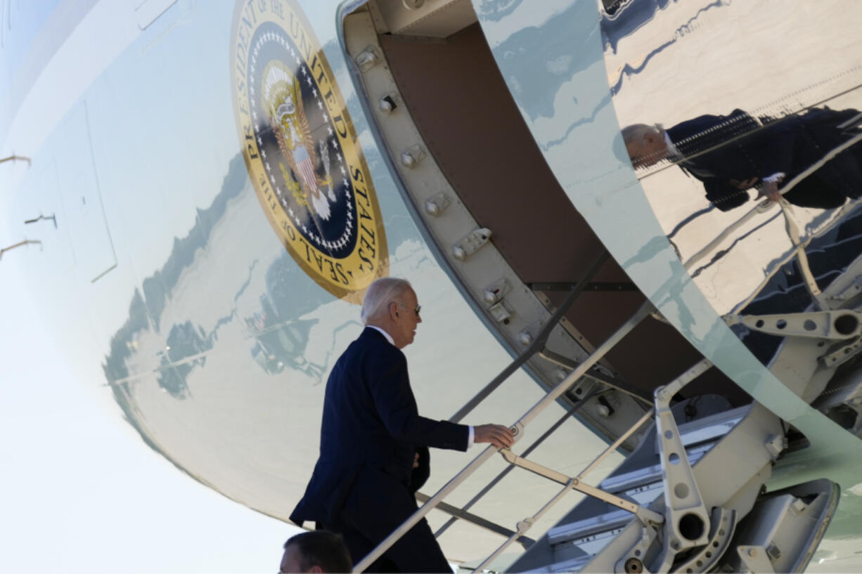President Joe Biden boards Air Force One at Dobbins Air Reserve Base in Marietta, Ga., Tuesday, Nov. 28, 2023, to travel to Denver after attending a tribute service for former first lady Rosalynn Carter in Atlanta.