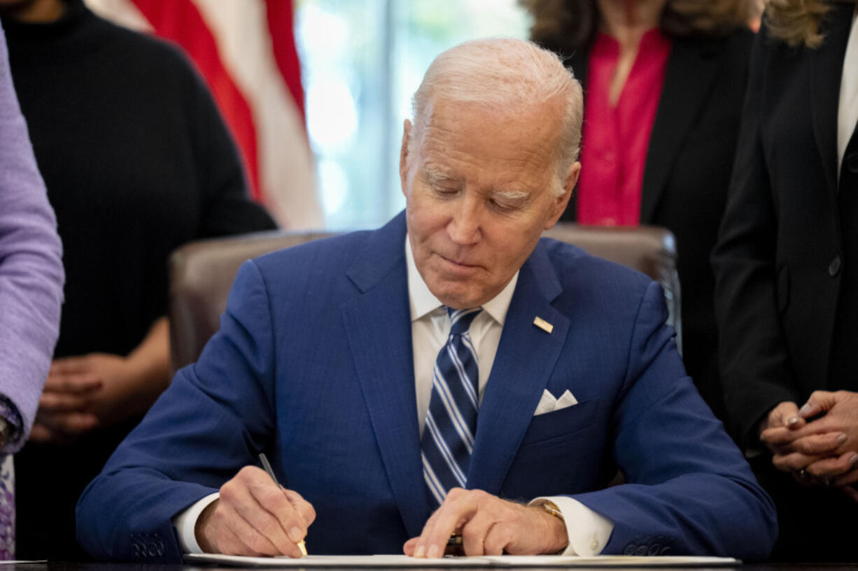 FILE - President Joe Biden signs a presidential memorandum in the Oval Office of the White House, Nov. 13, 2023, in Washington. Biden has announced five nominees to federal judgeships, including the first Muslim-American on any circuit court. The Democratic president is looking to add to more than 150 of his judicial selections that have already been confirmed to the bench.