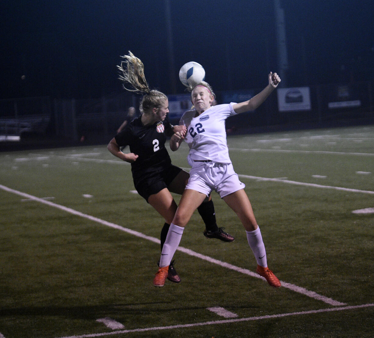 Camas' Savannah Kvistad (2) and Skyview's Piper Cameron (22) battle on a header during Camas' 2-0 win over Skyview in a Class 4A bi-district girls soccer playoff match at District Stadium in Battle Ground on Thursday, Nov. 2, 2023.