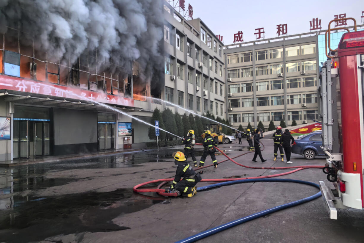 In this photo released by Xinhua News Agency, firefighters try to put out a fire at a building of the the Yongju Coal Company in Lyuliang city in northern China&rsquo;s Shanxi province, on Thursday, Nov. 16, 2023. A fire in the coal company building in a northern Chinese city has killed dozens of people and injured others.