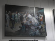 An art work depicting a Covid testing scene by Zeng Fanzhi, an retired architect turned artist, is seen at the Beijing art exposition in Beijing, Friday, Sept. 8, 2023. Zeng painted stark, realist portrayals of life in China under zero-COVID, saying he did so to capture a unique moment in history.