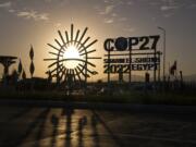 The sun sets behind the COP27 logo outside the venue of the COP27 U.N. Climate Summit on Nov. 12, 2022, in Sharm el-Sheikh, Egypt.