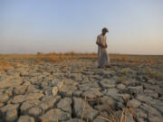 FIEL - A fisherman walks across a dry patch of land in the marshes in Dhi Qar province, Iraq, Sept. 2, 2022. The three-year drought that has left millions of people in Syria, Iraq and Iran with little water wouldn&rsquo;t have happened without human-caused climate change, according to a new study on Wednesday, Nov. 8, 2023.