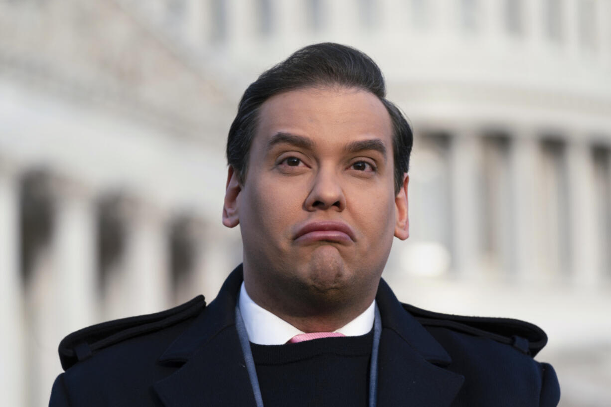 Rep. George Santos, R-N.Y., faces reporters at the Capitol in Washington, early Thursday, Nov. 30, 2023. After a scathing report by the House Ethics Committee citing egregious violations, Santos could be expelled from Congress this week. (AP Photo/J.