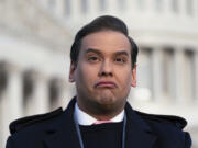 Rep. George Santos, R-N.Y., faces reporters at the Capitol in Washington, early Thursday, Nov. 30, 2023. After a scathing report by the House Ethics Committee citing egregious violations, Santos could be expelled from Congress this week. (AP Photo/J.