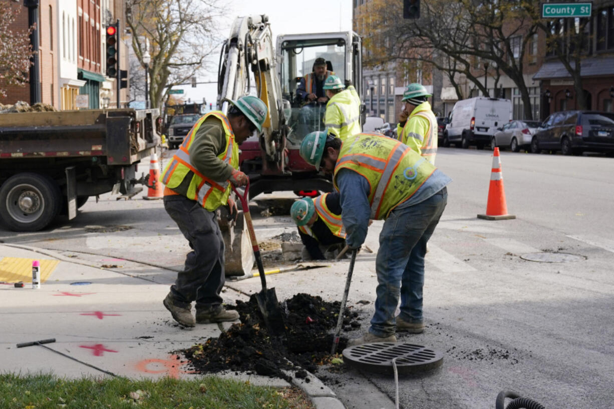 Workmen dig on a street in Waukegan, Ill., Monday, Nov. 6, 2023. On Wednesday, the Commerce Department issues its second of three estimates of how the U.S. economy performed in the third quarter of 2023. (AP Photo/Nam Y.