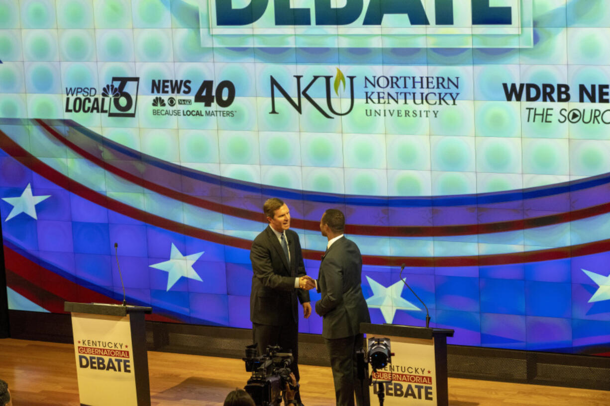 Democratic Gov. Andy Beshear, left, and Republican Attorney General Daniel Cameron shake hands at a gubernatorial debate at Northern Kentucky University, in Highland Heights, Ky., Monday, Oct. 16, 2023.