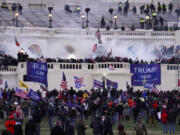 FILE - Violent rioters loyal to President Donald Trump storm the Capitol in Washington on Jan. 6, 2021. Lawsuits playing out in two states this week seeking to keep former President Donald Trump off the ballot rely on a constitutional clause barring those from office who "have engaged in insurrection." One challenge has become clear during the hearings in Colorado and Minnesota: No one can agree on how to define an insurrection.