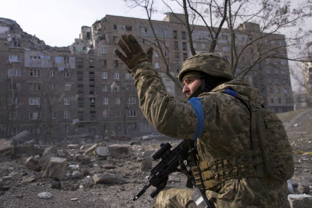 FILE - A Ukrainian serviceman guards his position in Mariupol, Ukraine, March 12, 2022.