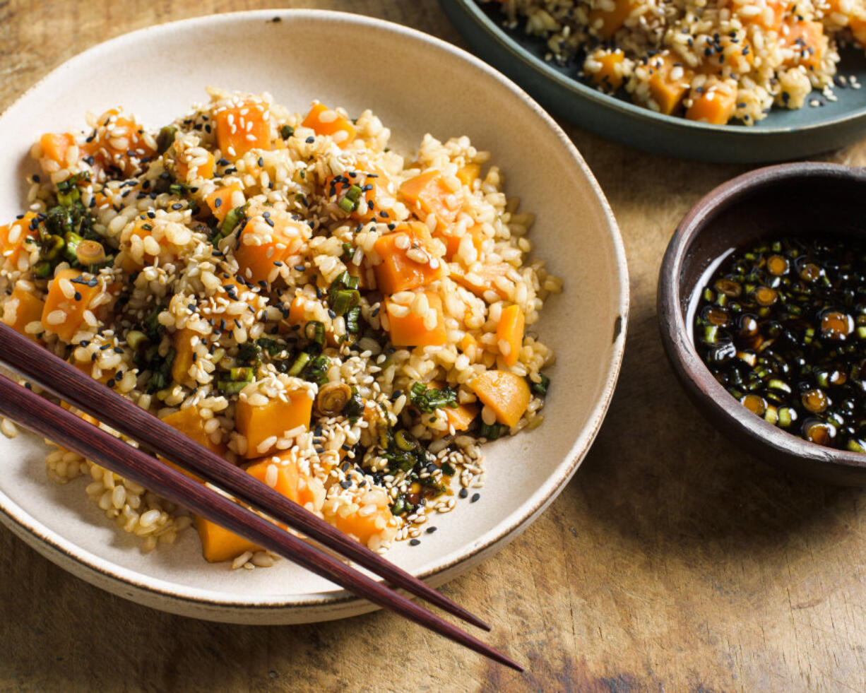 This image released by Milk Street shows a recipe for sweet potato brown rice with soy and scallions.