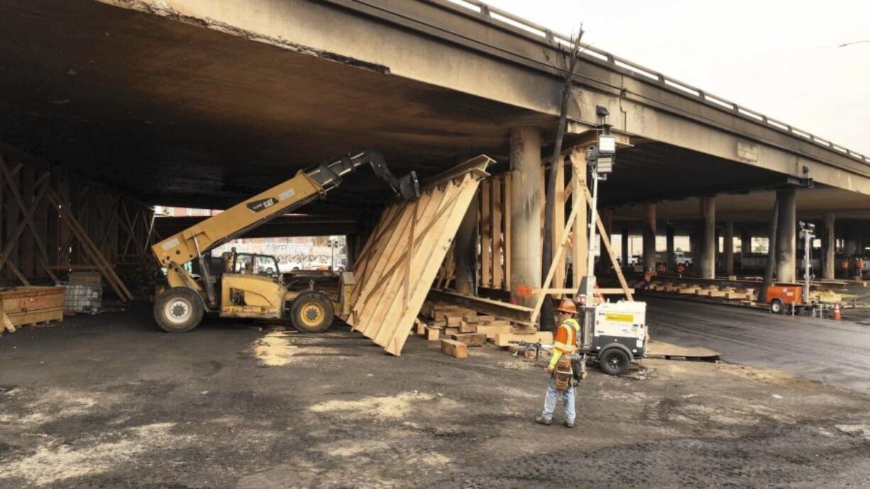 This photo provided by the California Department of Transportation shows a work crew shoring up a section under Interstate 10 that was severely damaged in a fire in an industrial zone near downtown Los Angeles on Wednesday, Nov. 15, 2023. The area under the freeway that burned last weekend, damaging a section of a key thoroughfare in the car-dependent city, was stacked with flammable materials on lots leased by the state through a little-known program that now is under scrutiny.