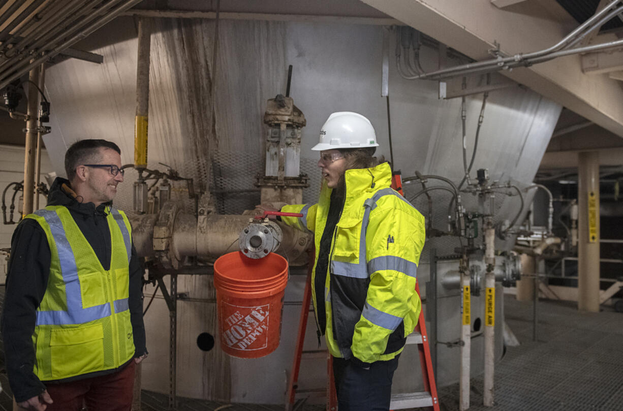 Frank Dick, left, Vancouver&rsquo;s wastewater engineering supervisor, chats with Sam Mielcarek, operations supervisor for Jacobs, as they tour the incinerator area of the city&rsquo;s wastewater facility Nov. 9. Vancouver is currently planning its wastewater solids renewal program, which will focus on resource recovery from wastewater.