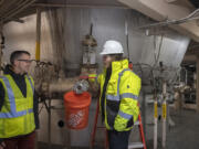 Frank Dick, left, Vancouver&rsquo;s wastewater engineering supervisor, chats with Sam Mielcarek, operations supervisor for Jacobs, as they tour the incinerator area of the city&rsquo;s wastewater facility Nov. 9. Vancouver is currently planning its wastewater solids renewal program, which will focus on resource recovery from wastewater.