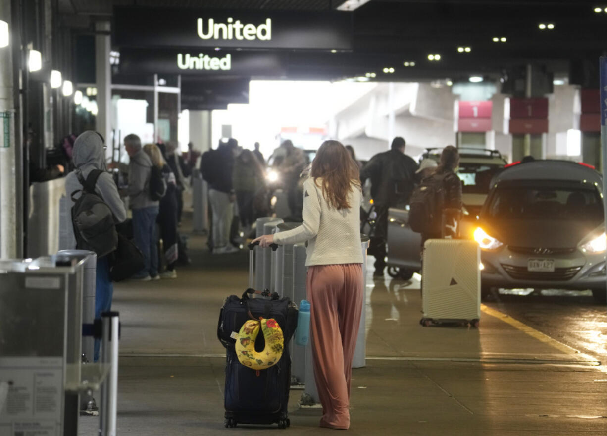 Travellers head into Denver International Airport on Monday, Nov. 20, 2023, in Denver. Despite inflation and memories of past holiday travel meltdowns, millions of people are expected to hit airports and highways in record numbers over the Thanksgiving Day break.