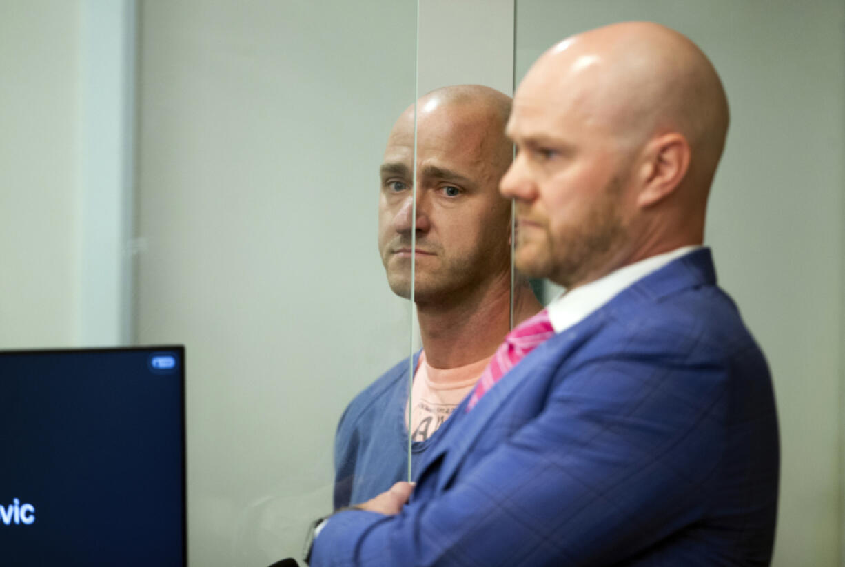 FILE - Joseph David Emerson, left, 44, is arraigned in Multnomah County Circuit Court, Oct. 24, 2023, in Portland, Ore. Three passengers sued Alaska Airlines on Thursday, Nov. 2, saying they suffered emotional distress from an incident last month in which Emerson, an off-duty pilot, was accused of trying to shut down the engines of a flight from Washington state to San Francisco.