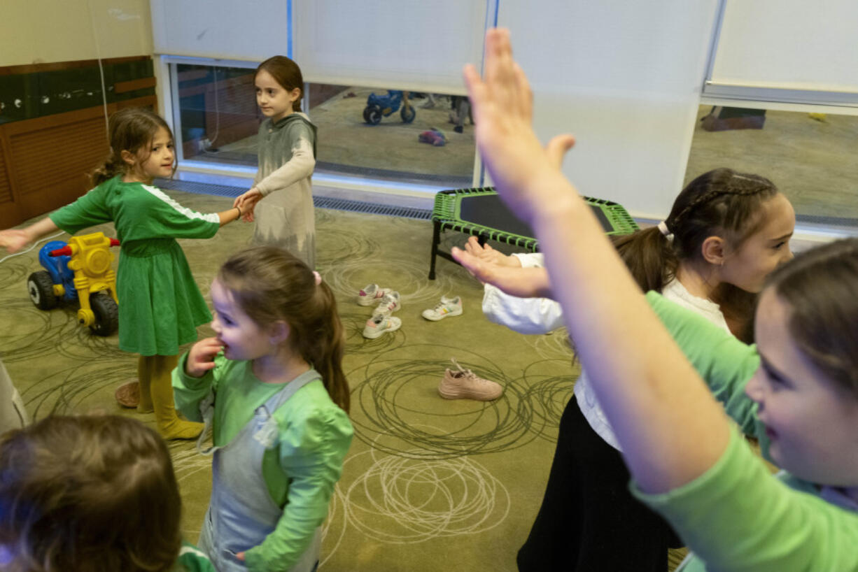 Young refugees from Israel play together in a Jewish refugee camp in Balatonoszod, Hungary, Tuesday Nov. 7, 2023. The camp, which houses around 250 people, including 100 children, provides shelter for Jewish refugees, some of whom escaped war both in Ukraine and Israel.