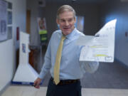 House Judiciary Committee Chair Jim Jordan, R-Ohio, holds an Justice Department email as he speaks with reporters after hearing from U.S. Attorney David Weiss in a transcribed interview before members of the House Judiciary Committee, Tuesday, Nov. 7, 2023, in Washington.