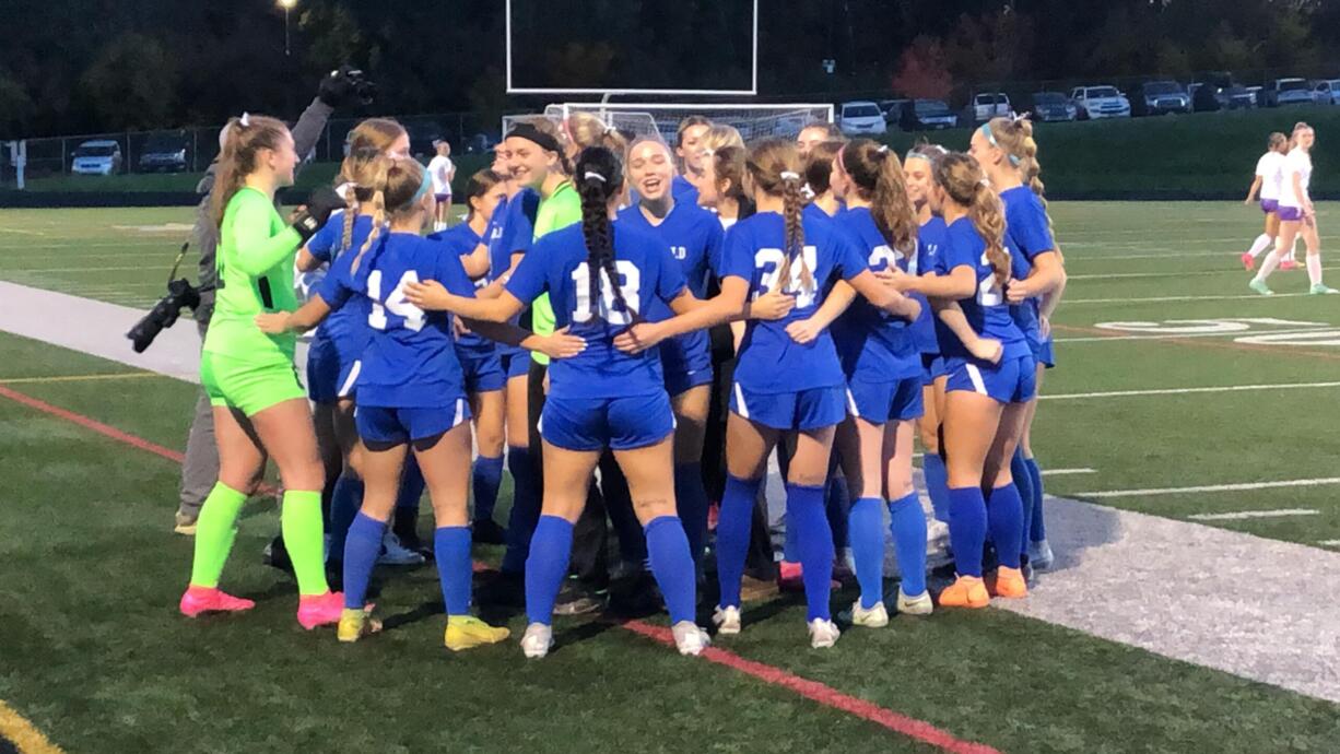 The Ridgefield girls soccer team huddles before a Class 2A state playoff match against Sequim on Wednesday, Nov. 8, 2023 at Ridgefield High School.