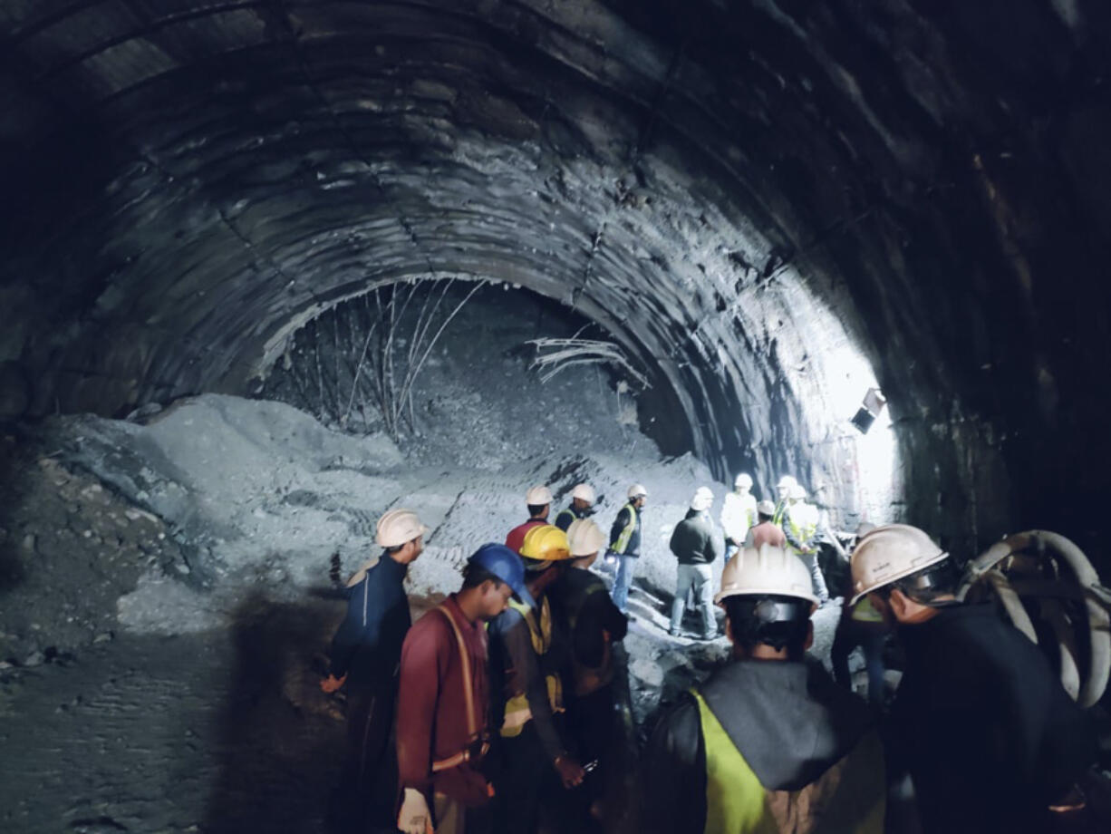 This photo provided by Uttarakhand State Disaster Response Force (SDRF) shows rescuers inside a collapsed road tunnel where more than 30 workers were trapped by a landslide in northern in Uttarakhand state, India, Sunday, Nov.12, 2023.