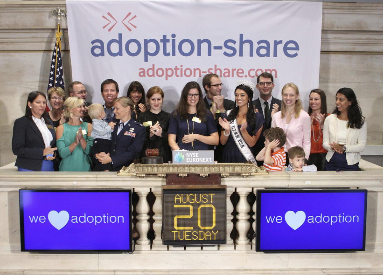 In this photo provided by the New York Stock Exchange, Adoption-Share founder and CEO Thea Ramirez, center, Miss Utah USA 2013 Marissa Powell, center right, and fellow adoption supporters ring the opening bell at the New York Stock Exchange in New York on Aug. 20, 2013. An Associated Press investigation found that Adoption-Share&rsquo;s tool known as Family-Match &ndash; among the few adoption algorithms on the market in 2023 &ndash; has produced limited results in the states where it has been used, according to the organization&rsquo;s self-reported data that AP obtained through public records requests from state and local agencies.