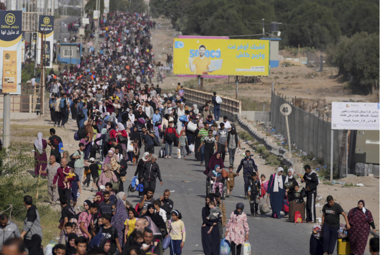 Palestinians flee to the southern Gaza Strip along Salah al-Din Street in Bureij, Gaza Strip, Thursday, Nov. 9, 2023.