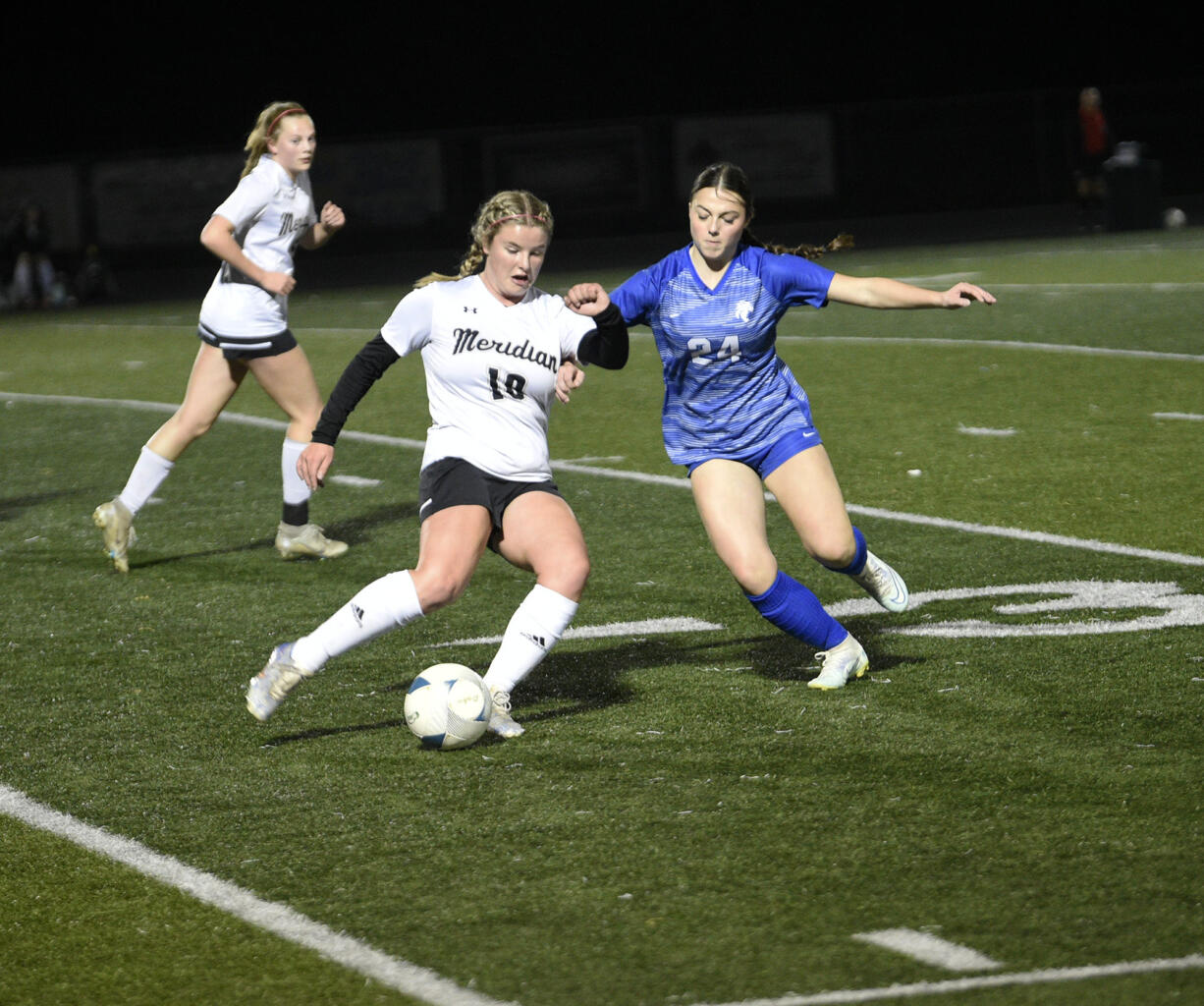 Meridian’s Katie Prengaman (10) and La Center’s Briley Vanderhoef (24) battle for the ball during the Wildcats’ 3-2 win over Meridian of Bellingham in a Class 1A girls soccer state tournament first-round match at Woodland High School on Wednesday, Nov. 8, 2023.