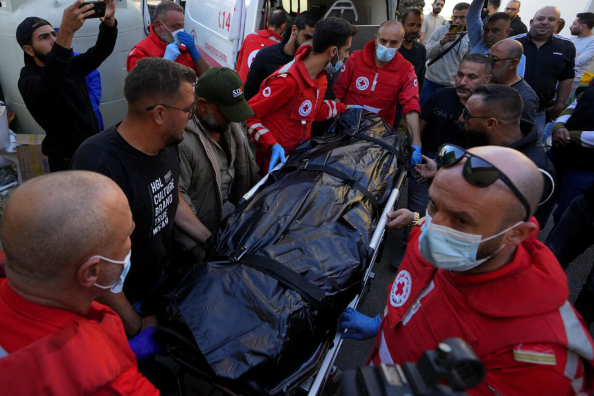 Lebanese Red Cross paramedics carry the body of Rabih Maamari, a cameraman at pan-Arab TV network Al-Mayadeen who was killed by an Israeli strike, at a hospital in Beirut, Lebanon, Tuesday, Nov. 21, 2023. An Israeli strike on southern Lebanon killed Tuesday two journalists reporting for the Beirut-based Al-Mayadeen TV on the violence along the border with Israel, according to the Lebanese information minister and their TV station.